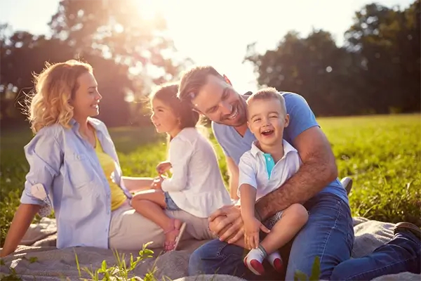 Family enjoying picnic in sunny Australian park.